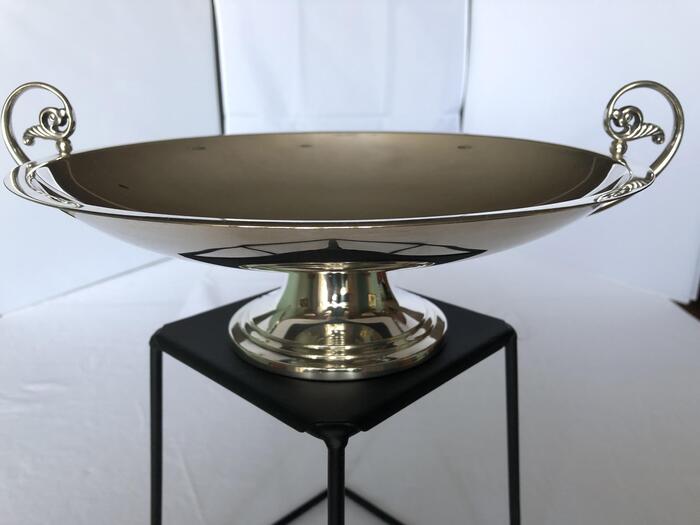 sterling footed, handled compote on black stand with white background